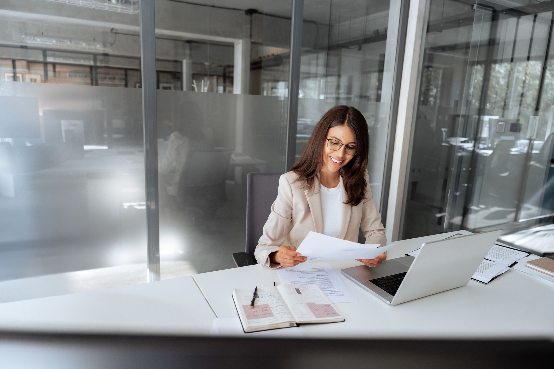 Latin business woman saleswoman working on laptop computer reading financial bank document in office workplace. Young entrepreneur manager businesswoman specialist doing paperwork using pc. Copy space
